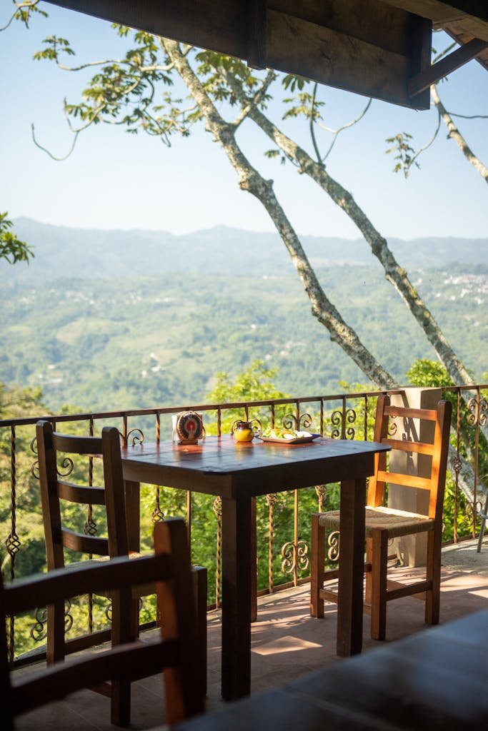 Charming al fresco dining setup overlooking scenic mountains, perfect for a relaxing outdoor meal.