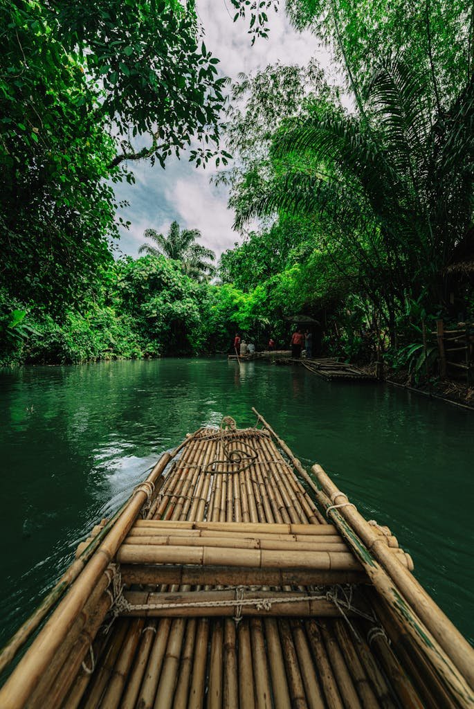 Experience the serene journey through Krabi's lush riverscape on a traditional bamboo raft.